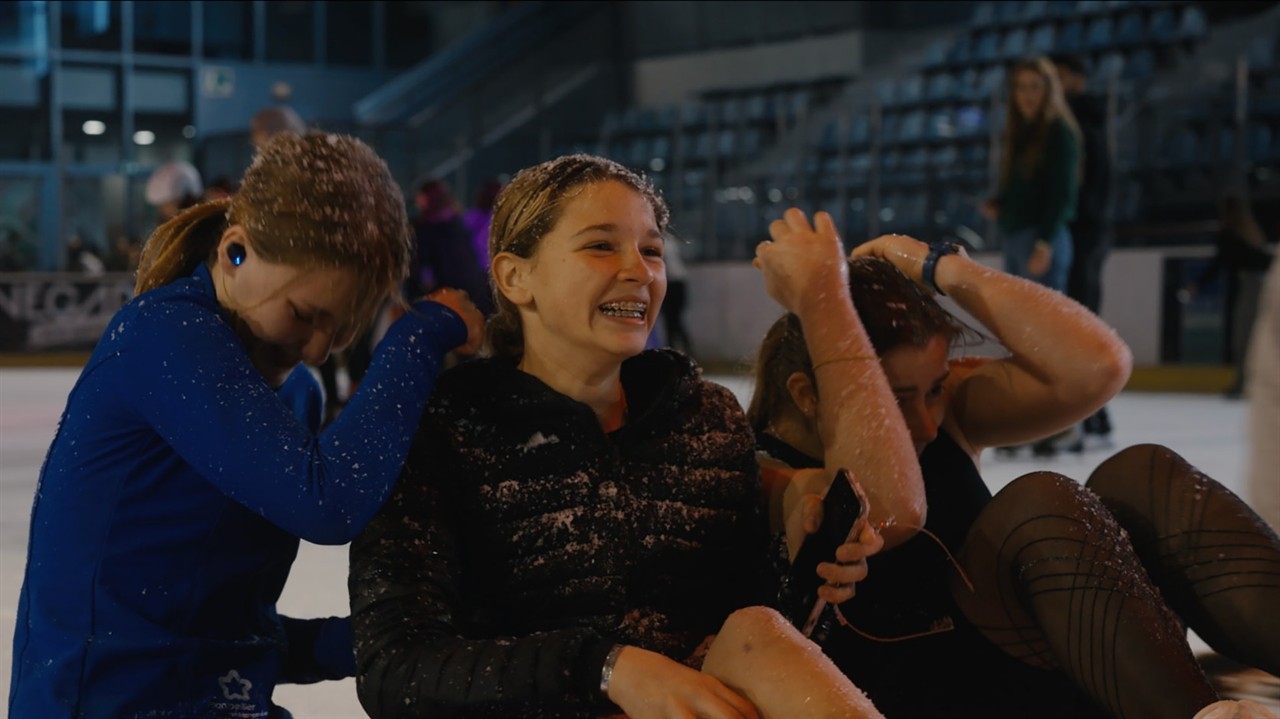 Group of teen girls laughing, covered in snow dust